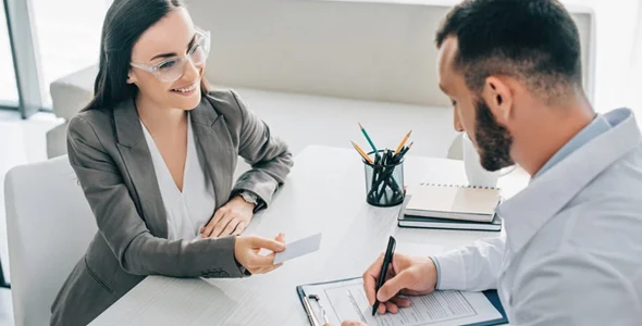 Insurance agent assisting clients with healthcare choices.