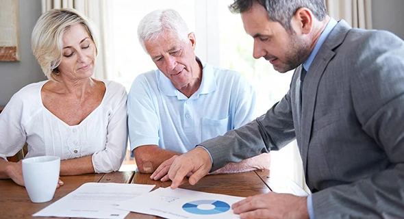 Seniors discussing retirement income planning options with a financial advisor in Buda, TX.